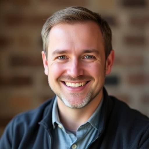 Headshot of Alistair Davies, acting instructor, smiling warmly.